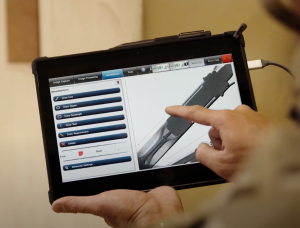 Someone pointing at an x-ray image in a tablet.