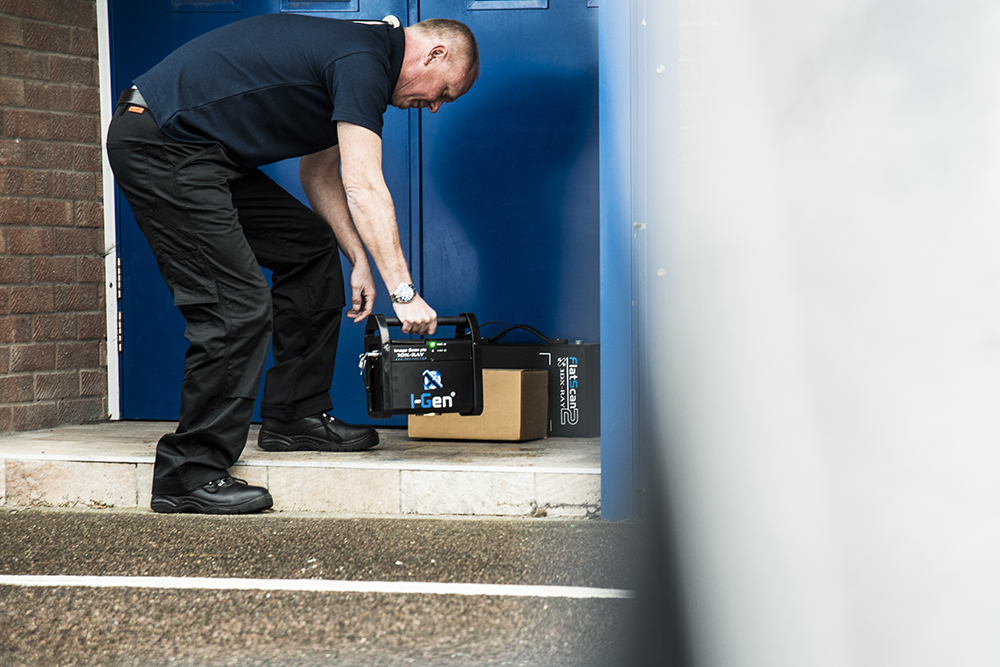 Technician deploying a portable X-ray system to inspect a suspicious package, demonstrating the safe use of X-ray radiation in security screening.